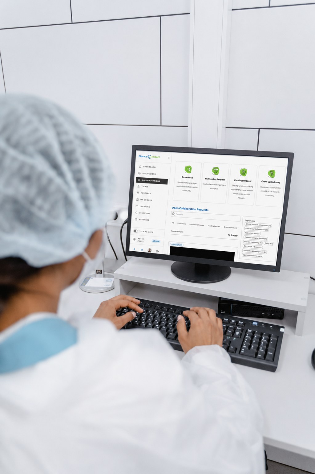 Clinician at a workstation reviewing open collaboration requests on the Elevate Impact platform